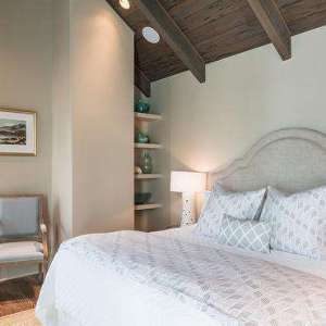 Dark Stained Vaulted Bedroom Ceiling with Wood Beams